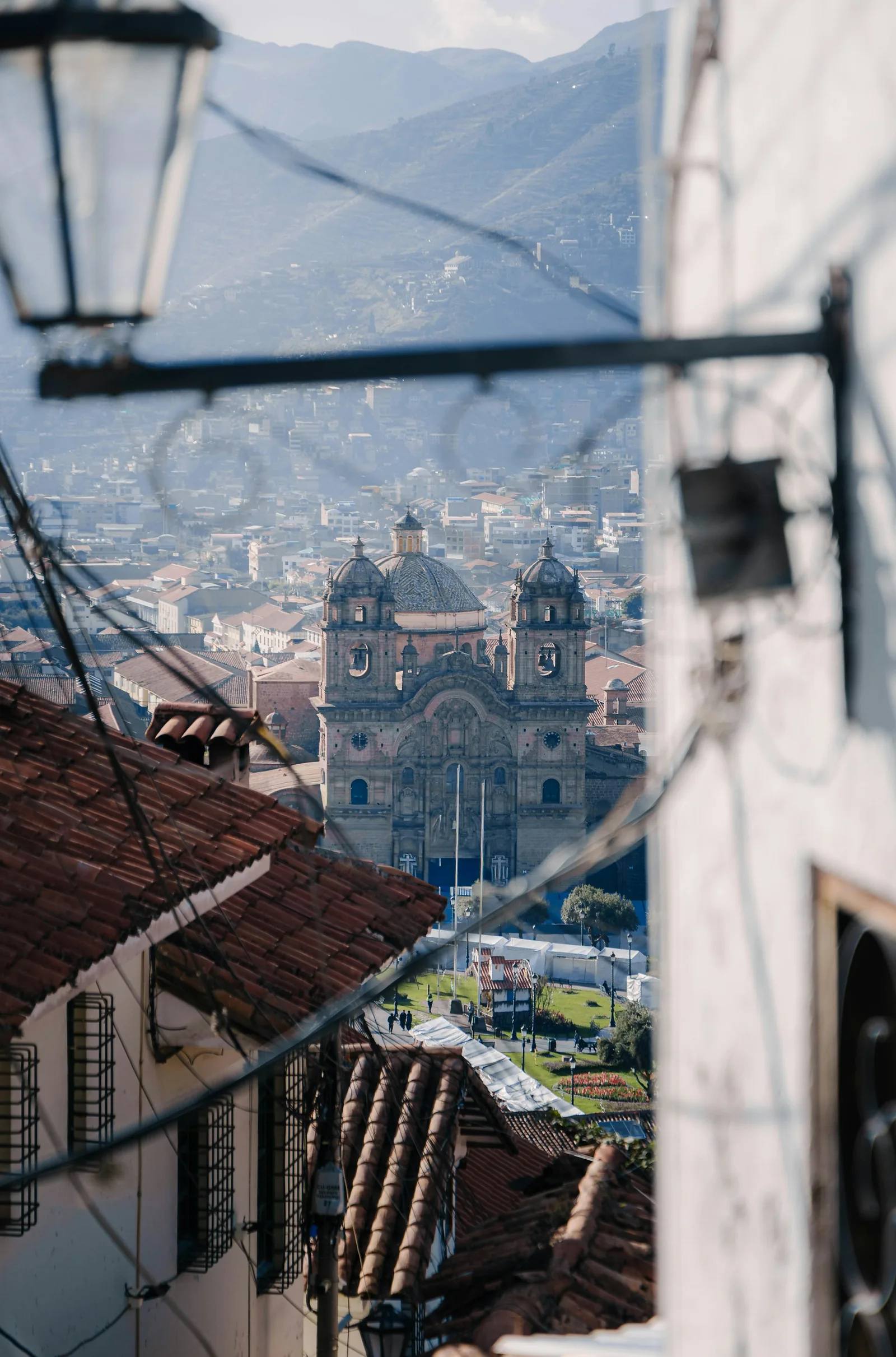 A historic cathedral and city buildings in Cusco, Peru