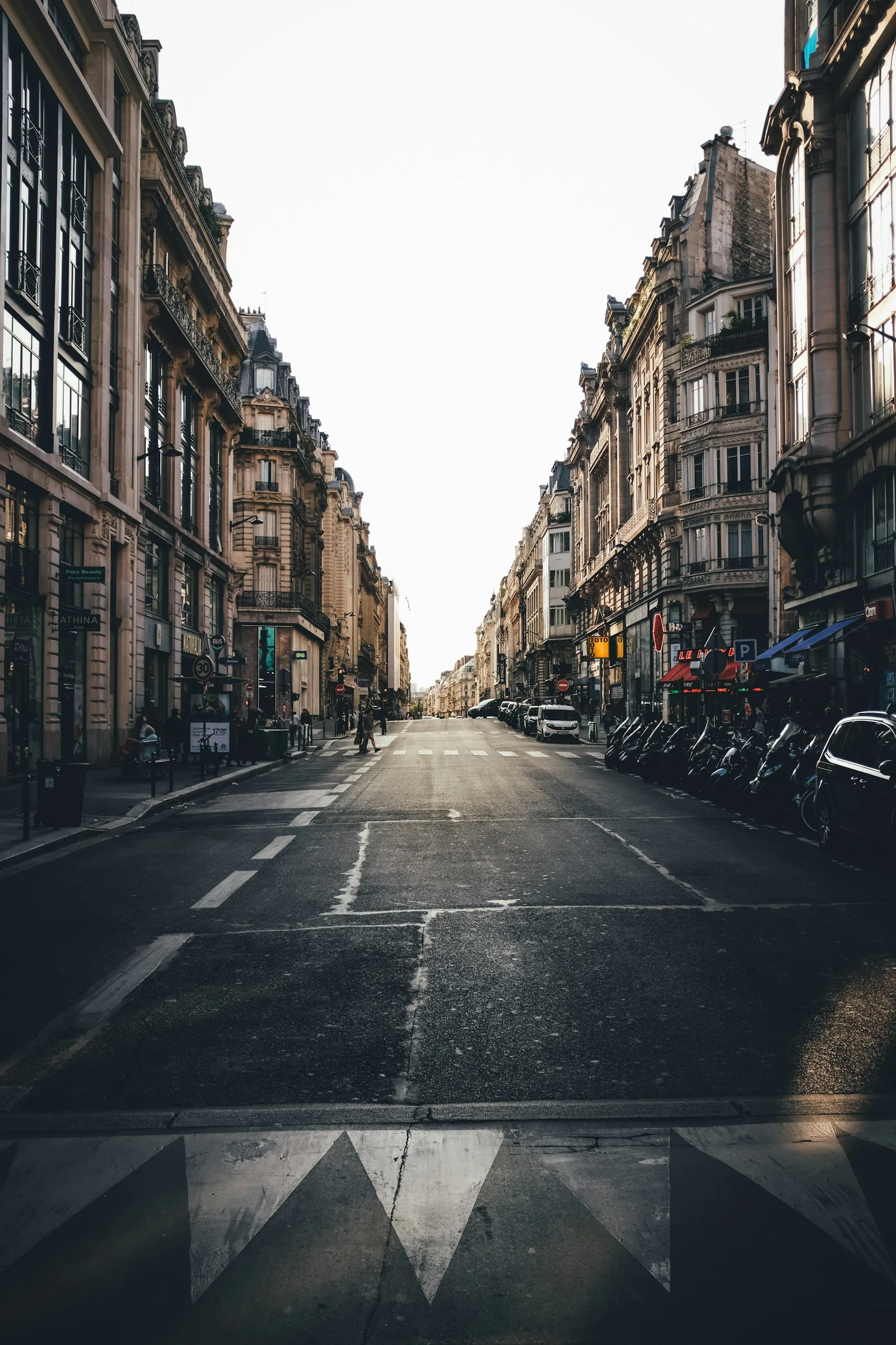A quiet Paris street between stone buildings